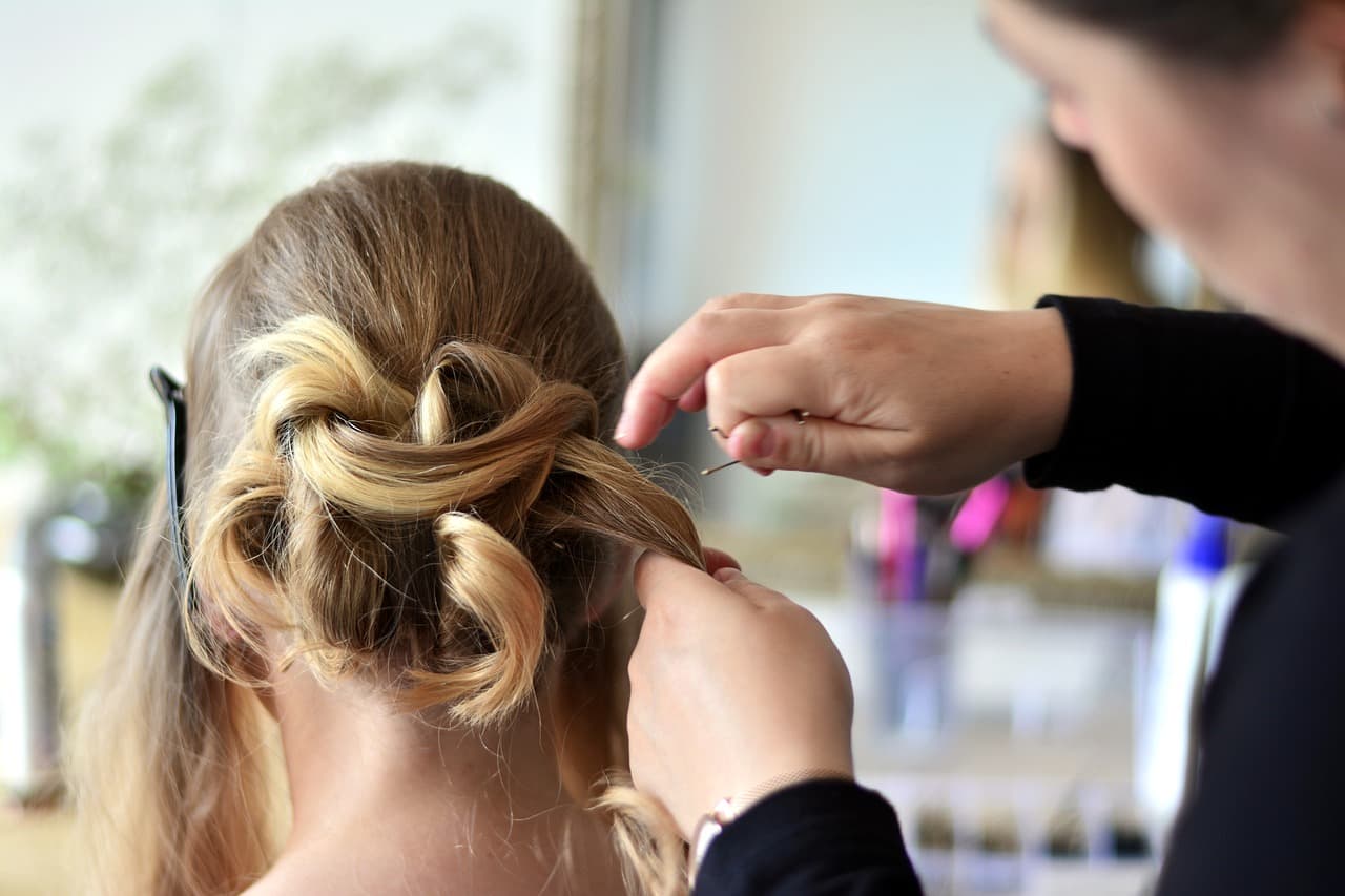 A stylist working on a client in a salon
