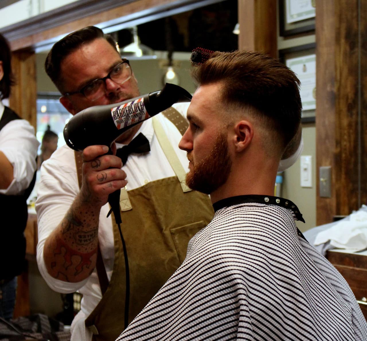 A barber cutting a client's hair
